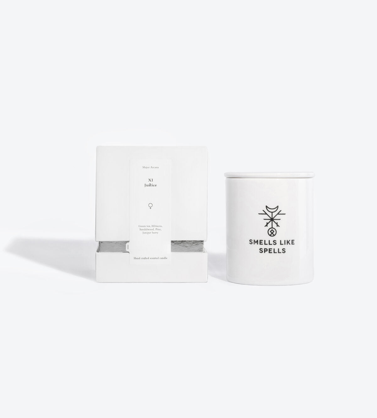 elegant justice tarot candle in handmade porcelain, glowing with a soft amber light on a minimalist altar