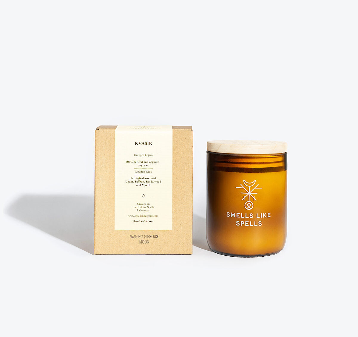 playful kvasir scented candle glowing on a wooden table, its amber glass jar casting a warm, inviting light