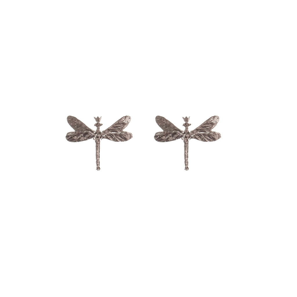 soft silver dragonfly earrings with gemstones glowing in warm light