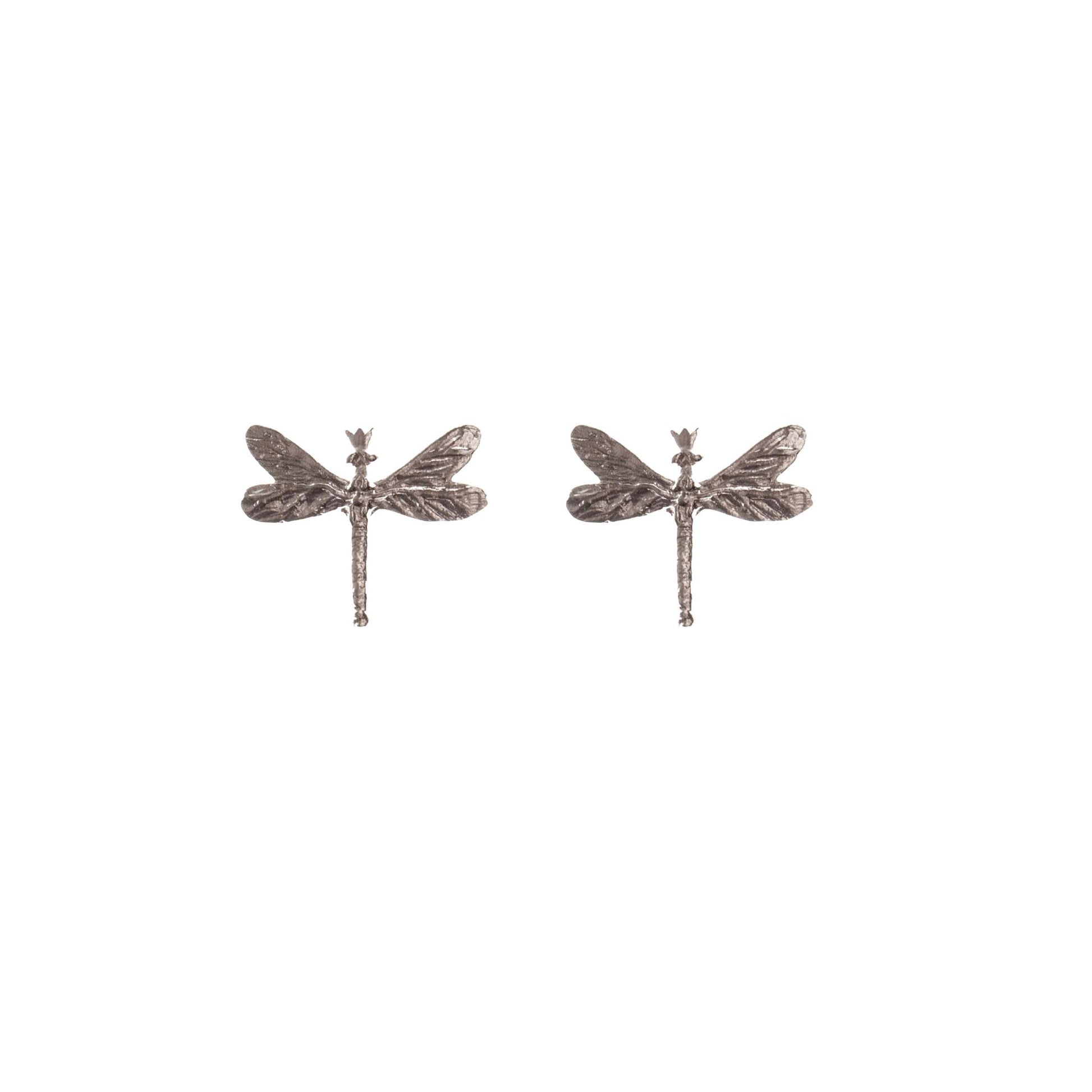 soft silver dragonfly earrings with gemstones glowing in warm light