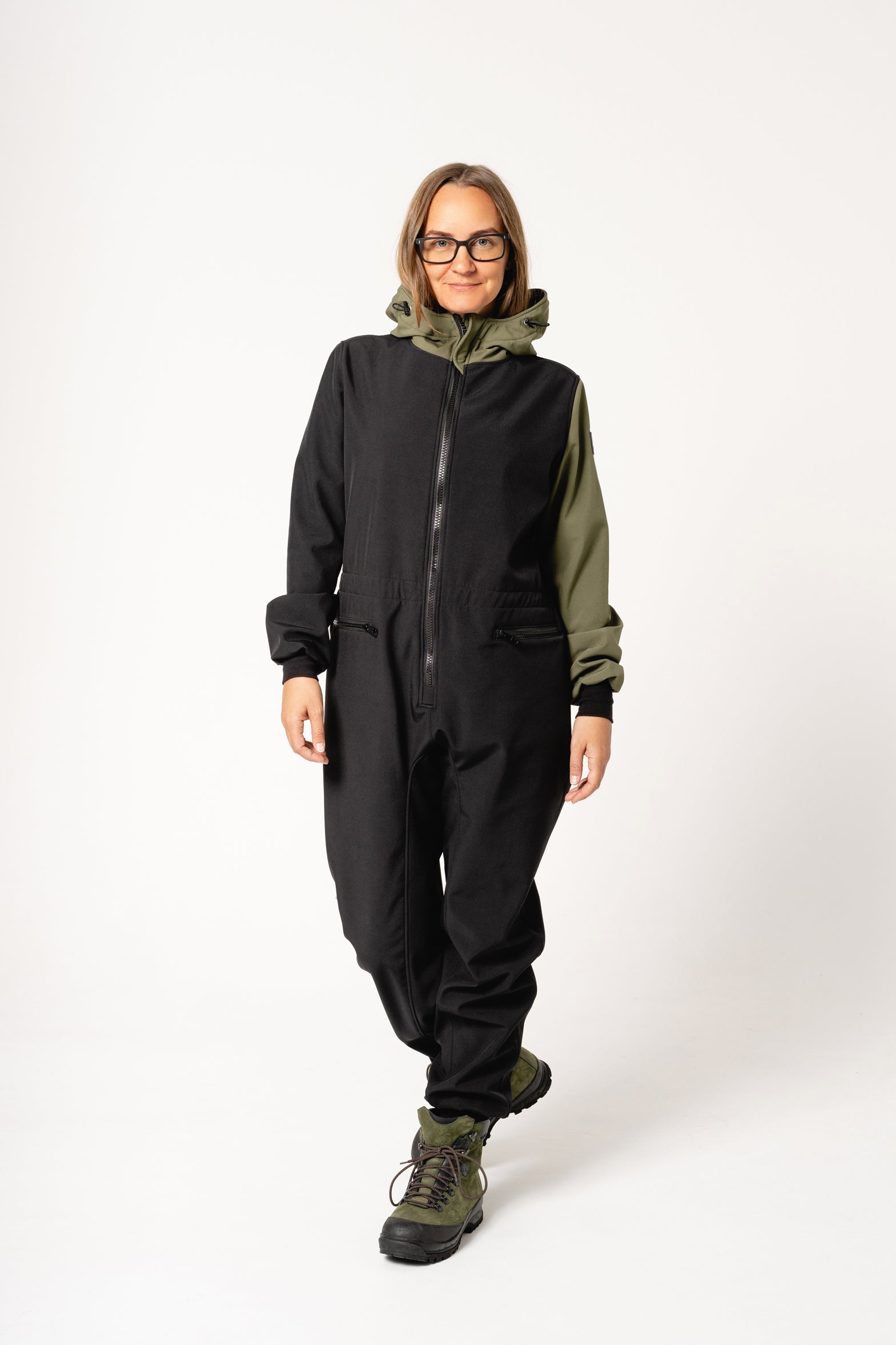 a woman in a softshell carola overall smiling warmly on a misty forest trail