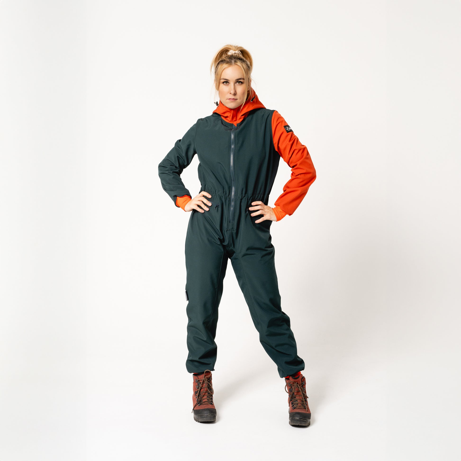 bold woman in a stylish waterproof softshell overall confidently facing the elements