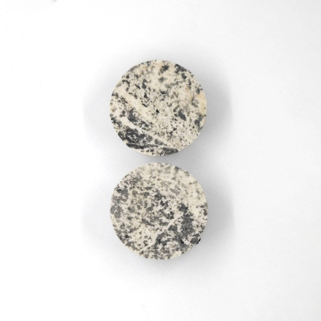 bold slate and marble orbit kohev lumi earrings in dramatic studio lighting