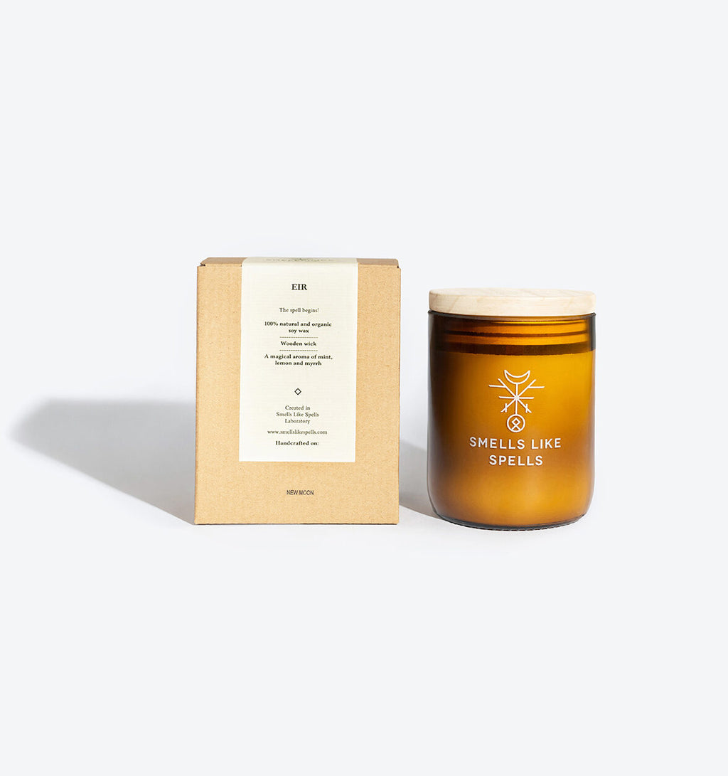 a playful amber jar candle with a glowing wooden wick and vibrant mint-lime-myrrh scent