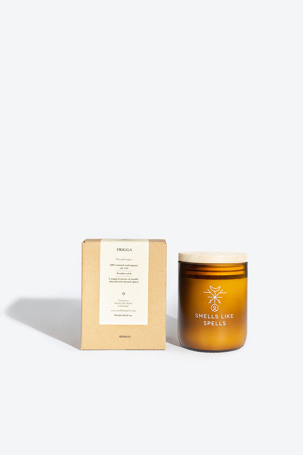 bold close-up of the frigg scented candle with its amber glass jar and wooden wick, radiating warmth and protection