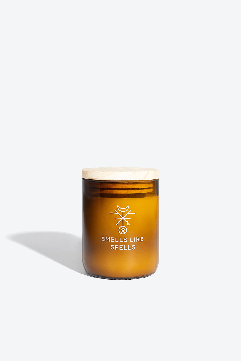 softly glowing mimir scented candle in amber glass, casting a warm and comforting lavender-sandalwood aura