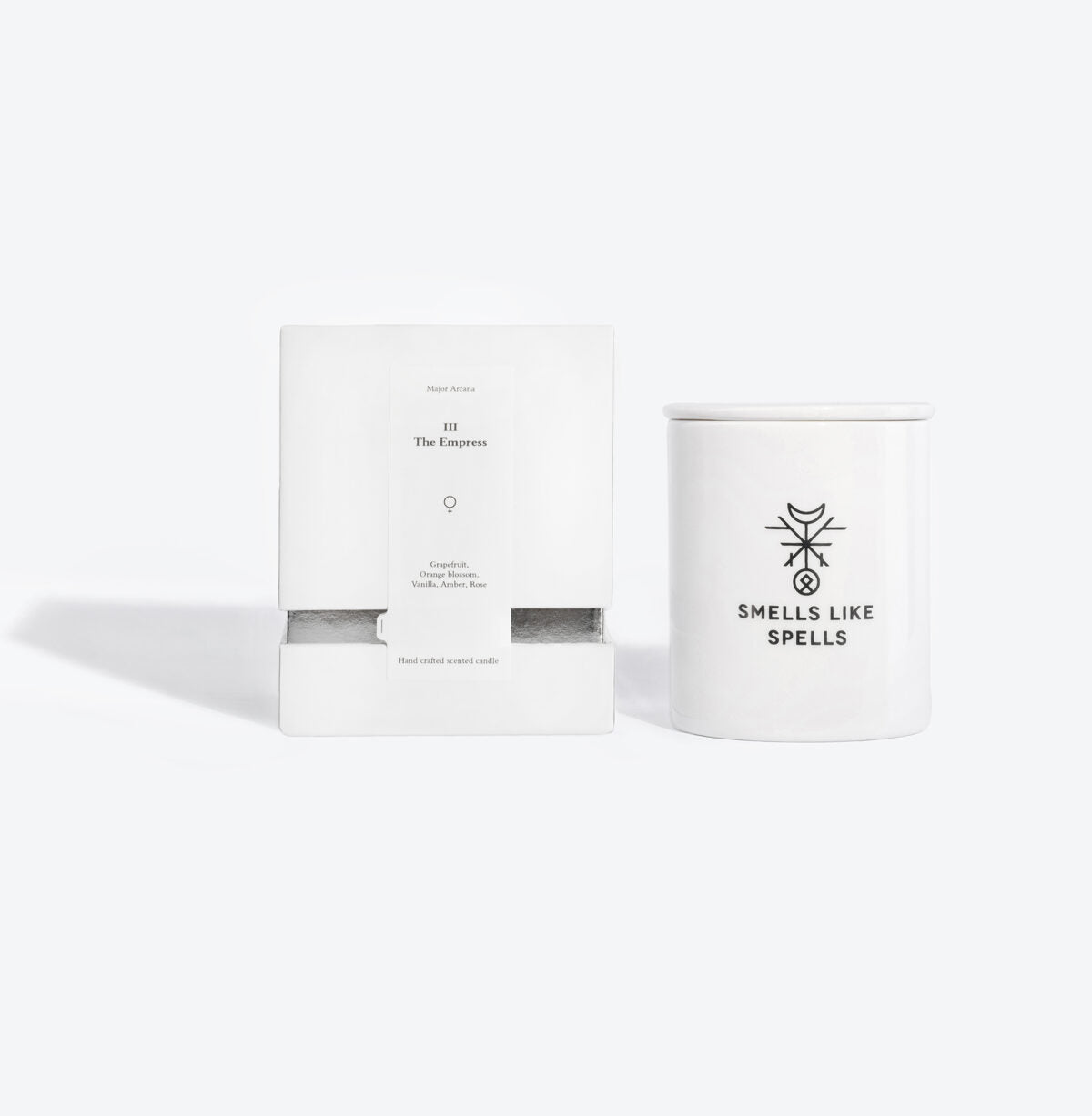 the empress tarot candle glowing elegantly in a soft-lit room with its hand-made porcelain container