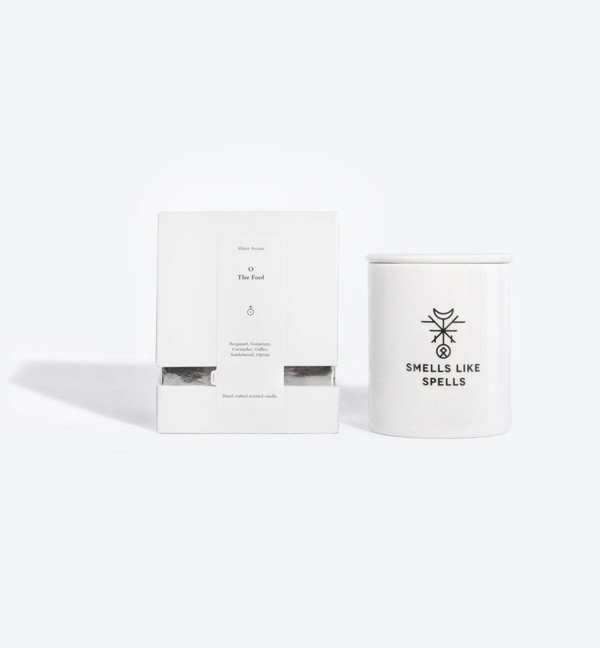elegant the fool tarot candle in a handmade porcelain vessel, glowing with a soft flame against a minimalist backdrop