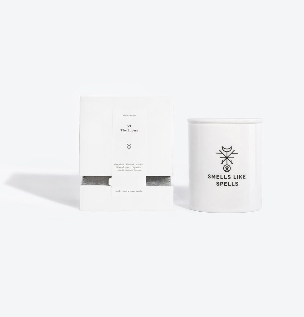 elegant porcelain lovers tarot candle glowing with a warm, inviting light on a sophisticated table
