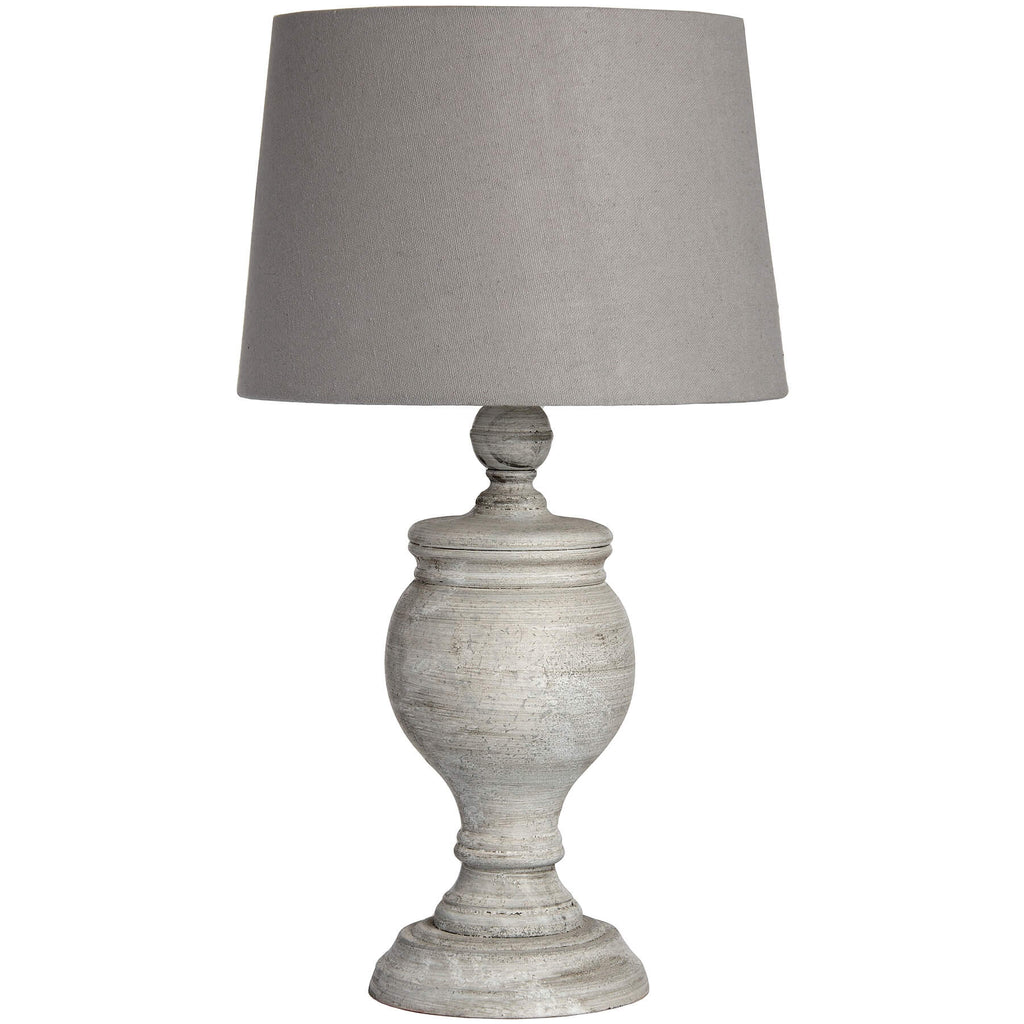 Uthina table lamp with wood base and linen shade in warm beige, creating soft ambient lighting for modern or traditional decor by Sostter at brixbailey.com