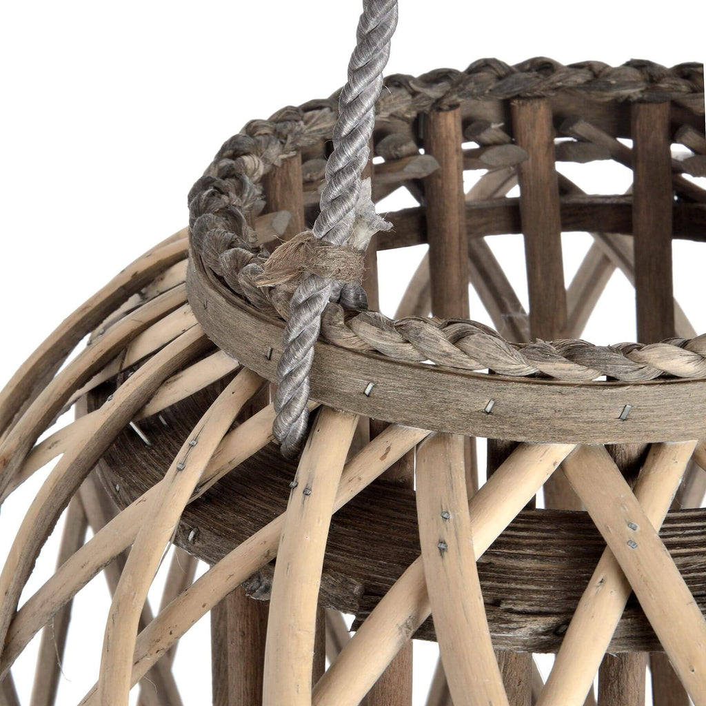 Handwoven wicker lantern with intricate rattan weave, warm brown finish, creates atmospheric light patterns for indoor or outdoor decor. by sostter at brixbailey.com