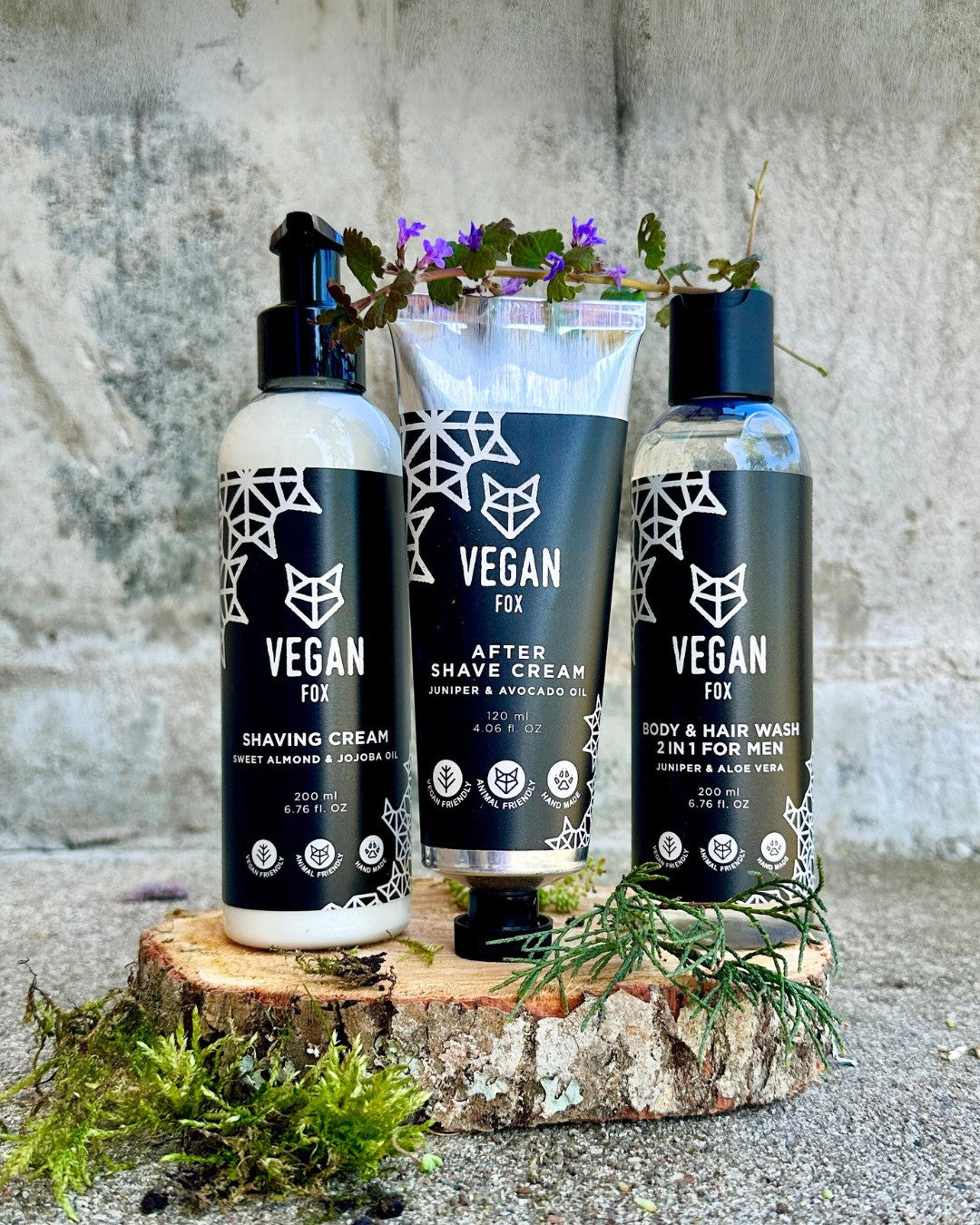 playful shot of men's vegan grooming set with grapefruit-cedar scent, bottles splashing