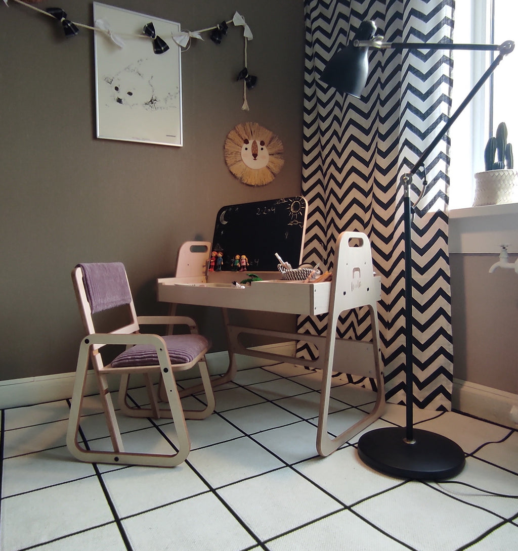 pink ergonomic kids chair with soft velvet upholstery on a modern wood floor