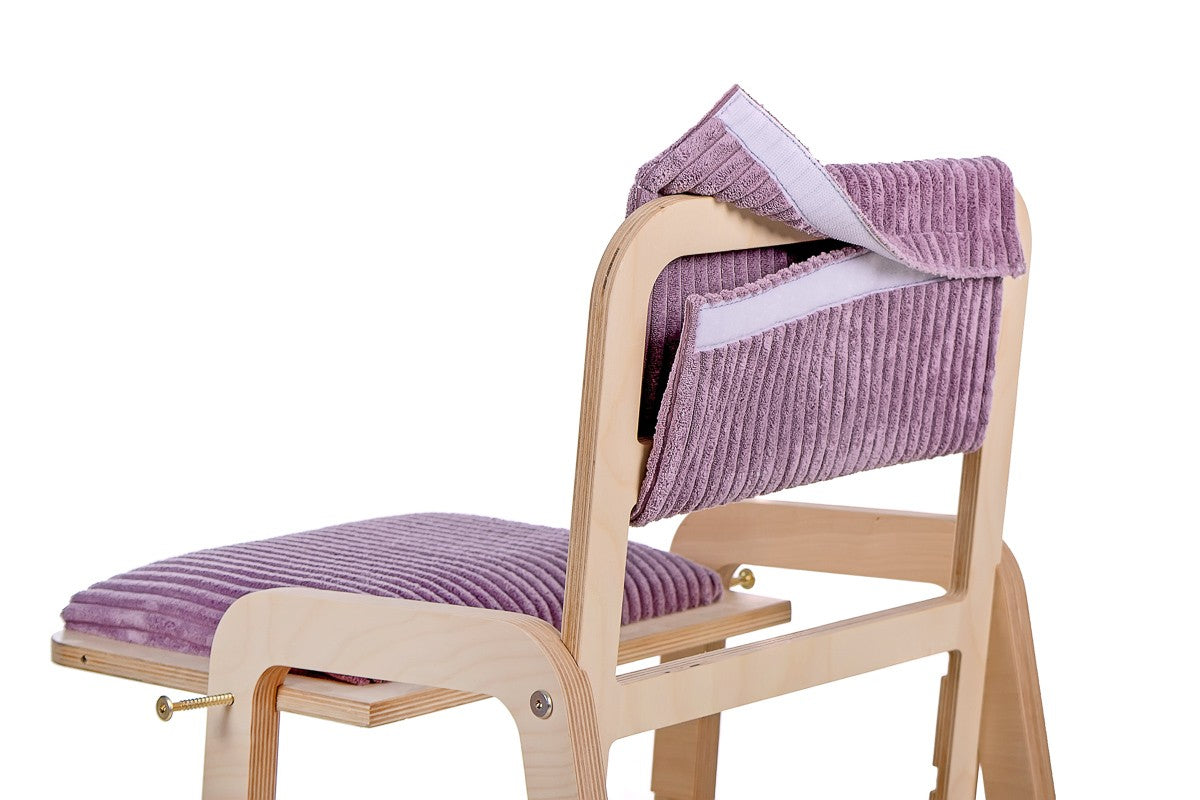 a functional view of the adjustable pink kids chair showing its stable birch wood base and connected legs