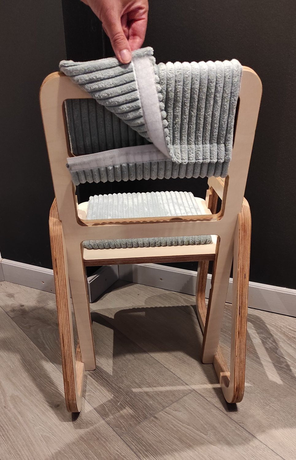 soft mint green kids chair with plush padding and natural birch wood in a cozy nursery setting