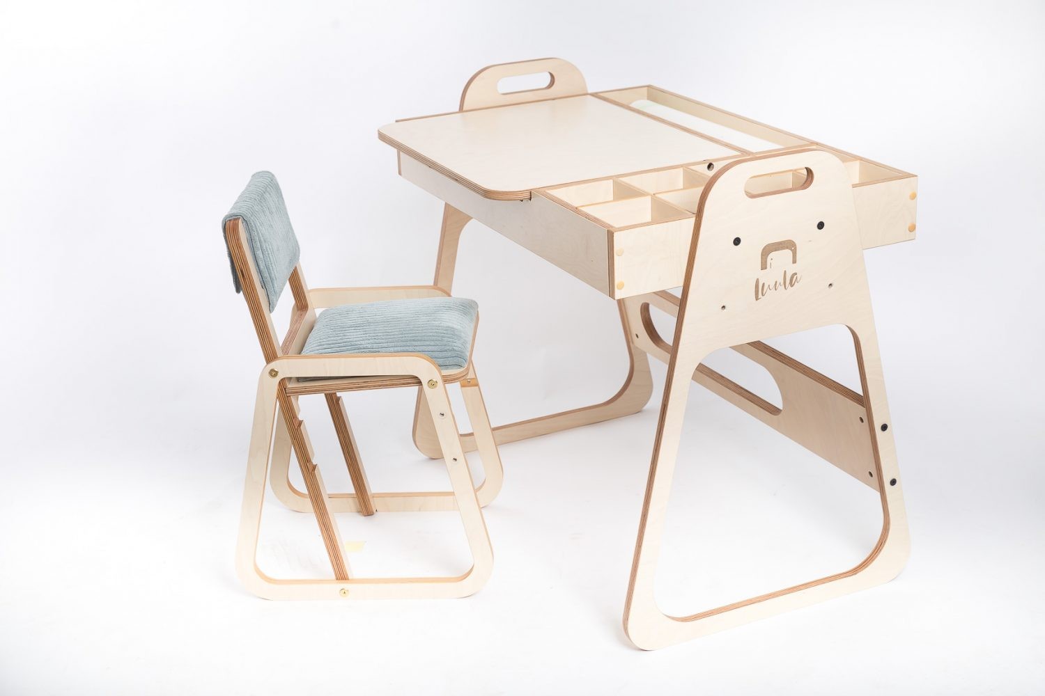 mint green julle kids chair in a bright playroom, showcasing its adjustable birch plywood frame and plush seat