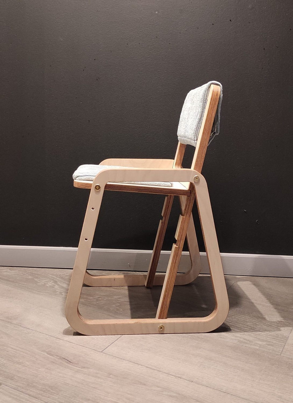 mint green julle kids chair in a bright, airy nursery with morning light highlighting its smooth birch wood grain