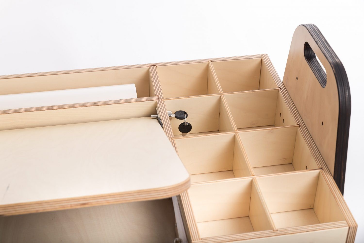 mint green kids art table with side storage bins and a paper roll in a bright, sunlit playroom