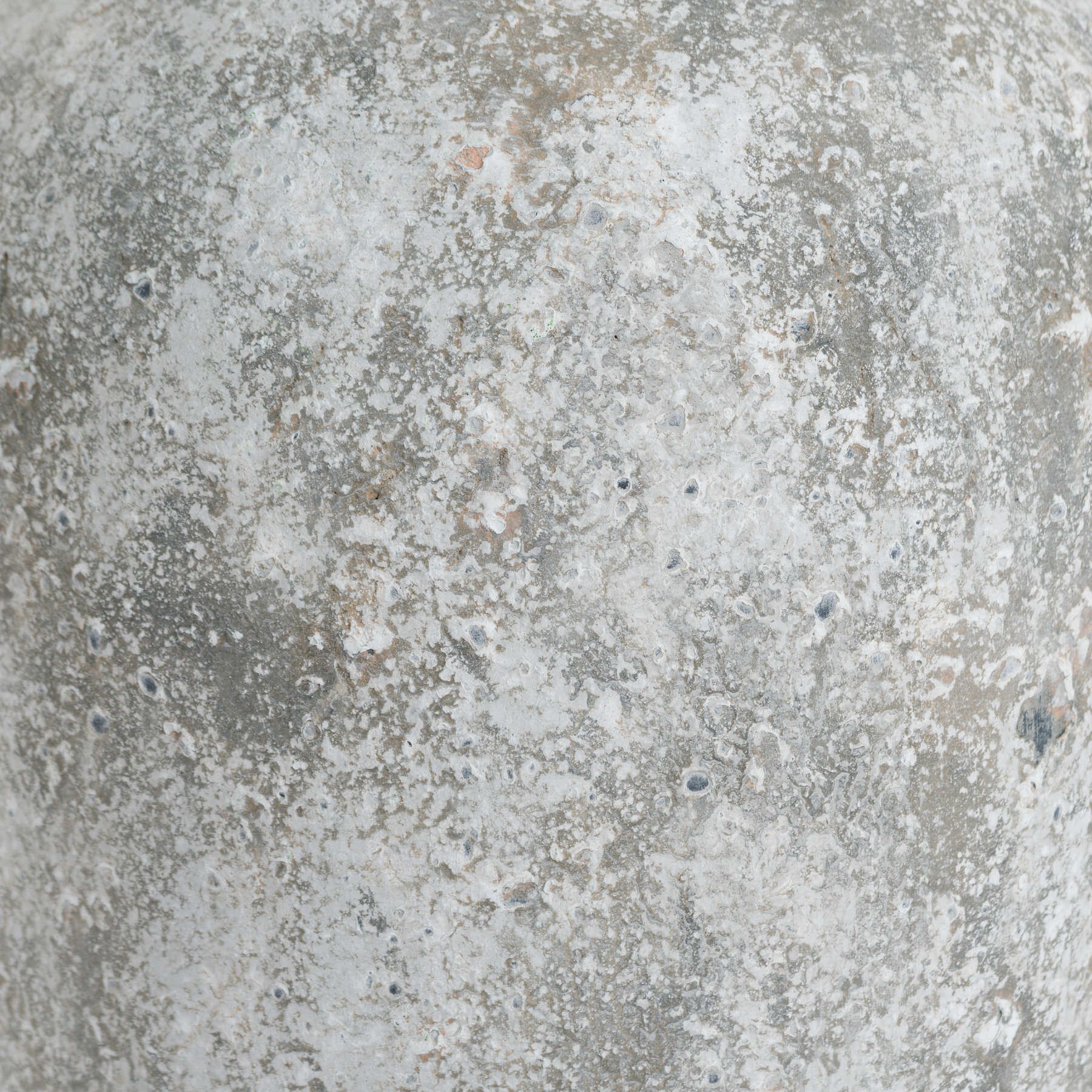softly lit tall ceramic vase with a comforting aged stone texture in a cozy home setting