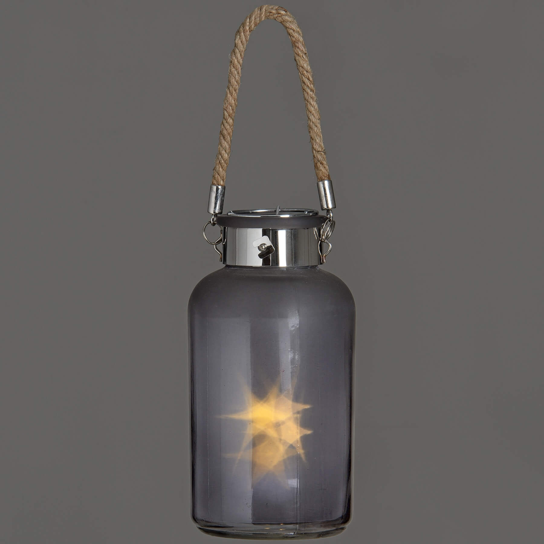 Frosted grey glass lantern with LED starlight glow, rope handle, and rustic modern design for indoor or outdoor ambiance by sostter at brixbailey.com