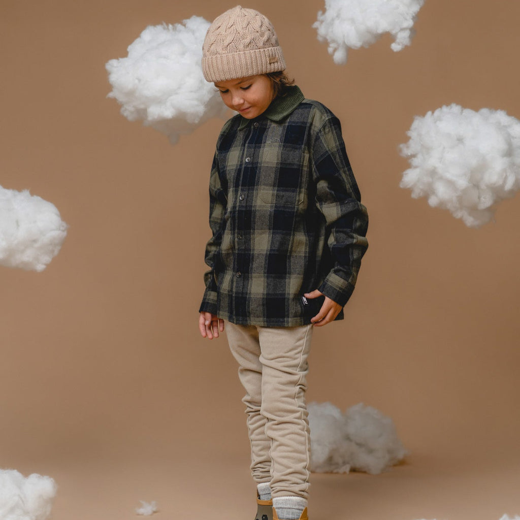 bold wheat-colored alpaca cable hat for kids, front view showcasing its chunky knit and sustainable luxury