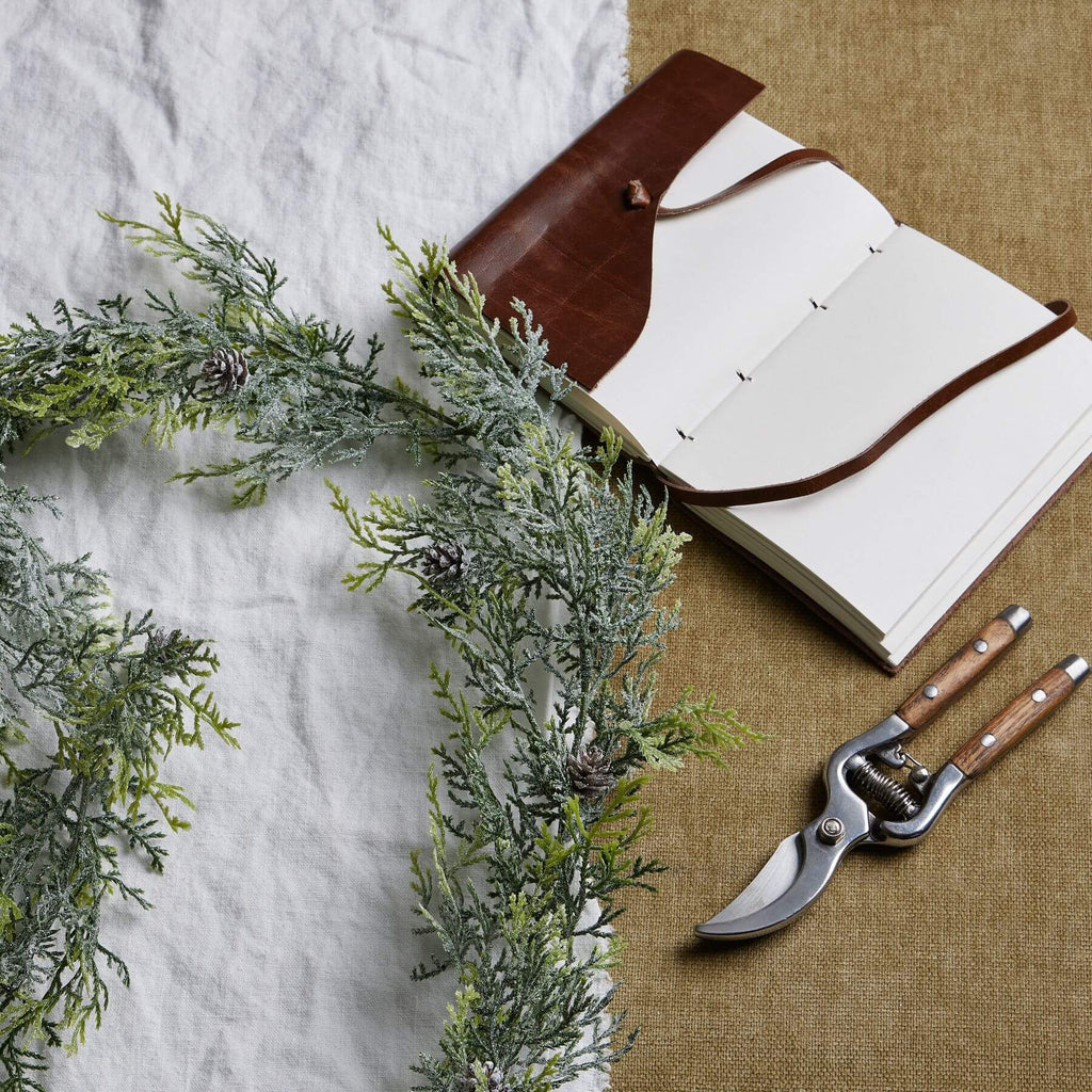 Frost-dusted pine garland with lifelike needles and pinecones, natural white with sparkling frost accents, 180cm long. by sostter at brixbailey.com