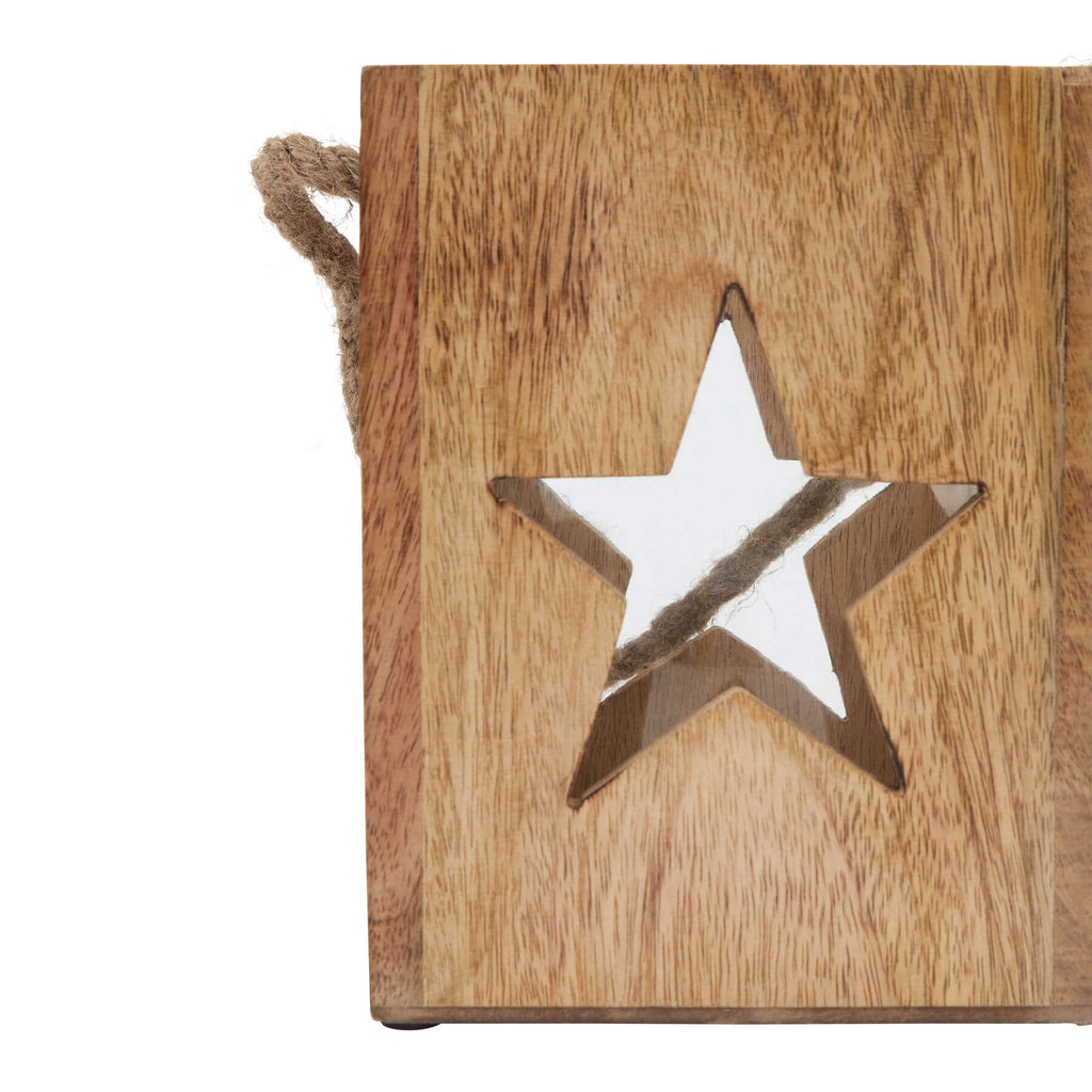 Handcrafted wooden star tealight holder with celestial design, casting warm glow in rustic brown finish for boho home decor. by RoomLondon at brixbailey.com