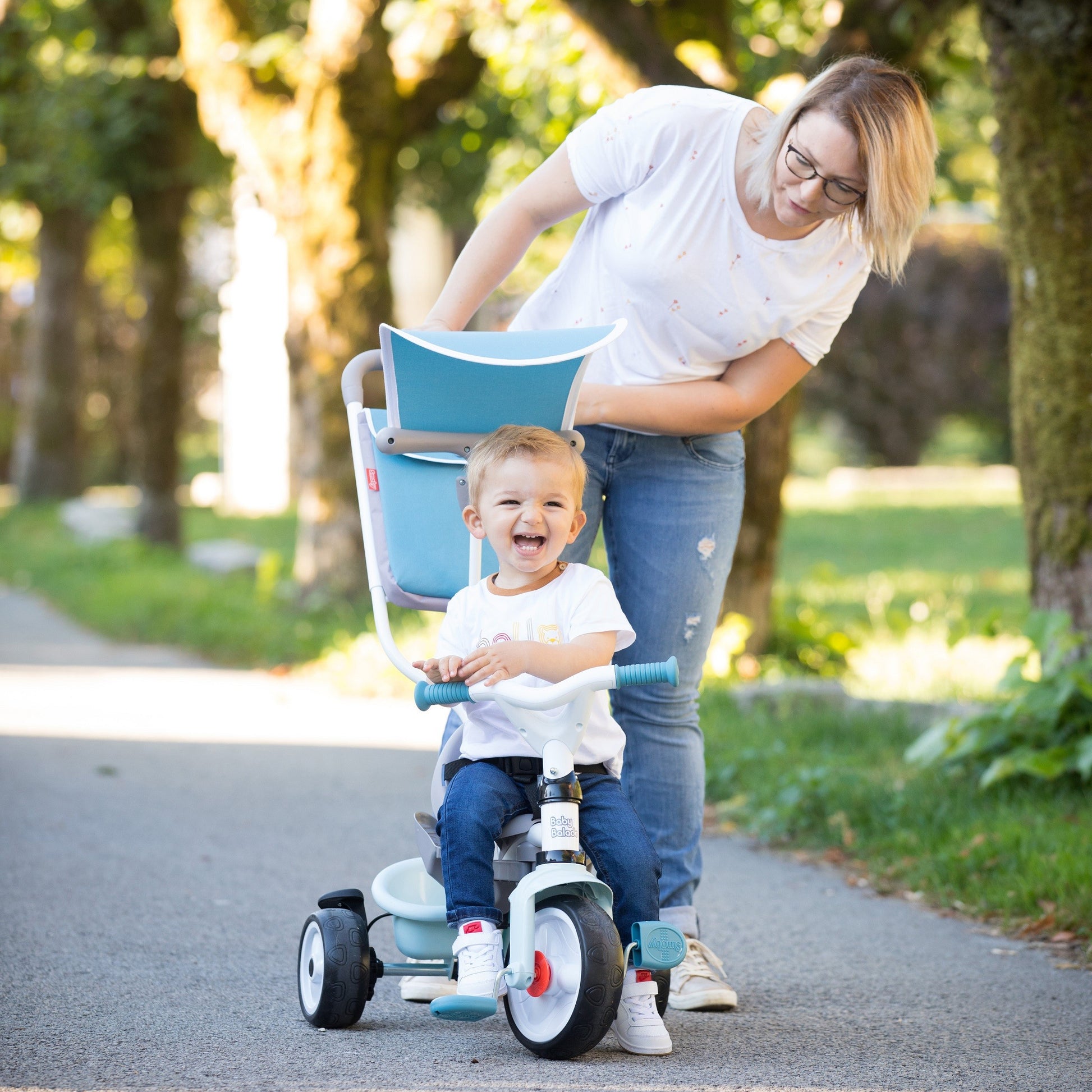 elegant blue baby tricycle with a built-in sun visor and smart storage bag