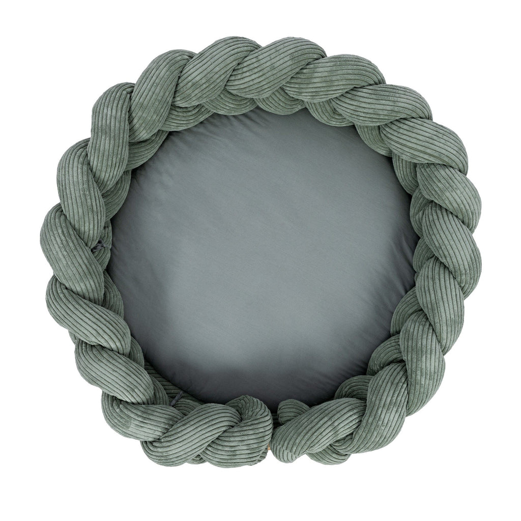 bold olive green baby nest with intricate braided bumper on a clean white background