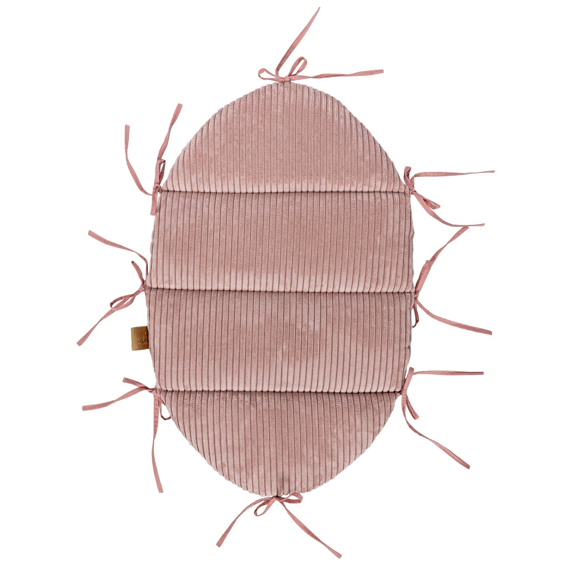 powder pink baby nest with soft corduroy braid in a cozy nursery setting