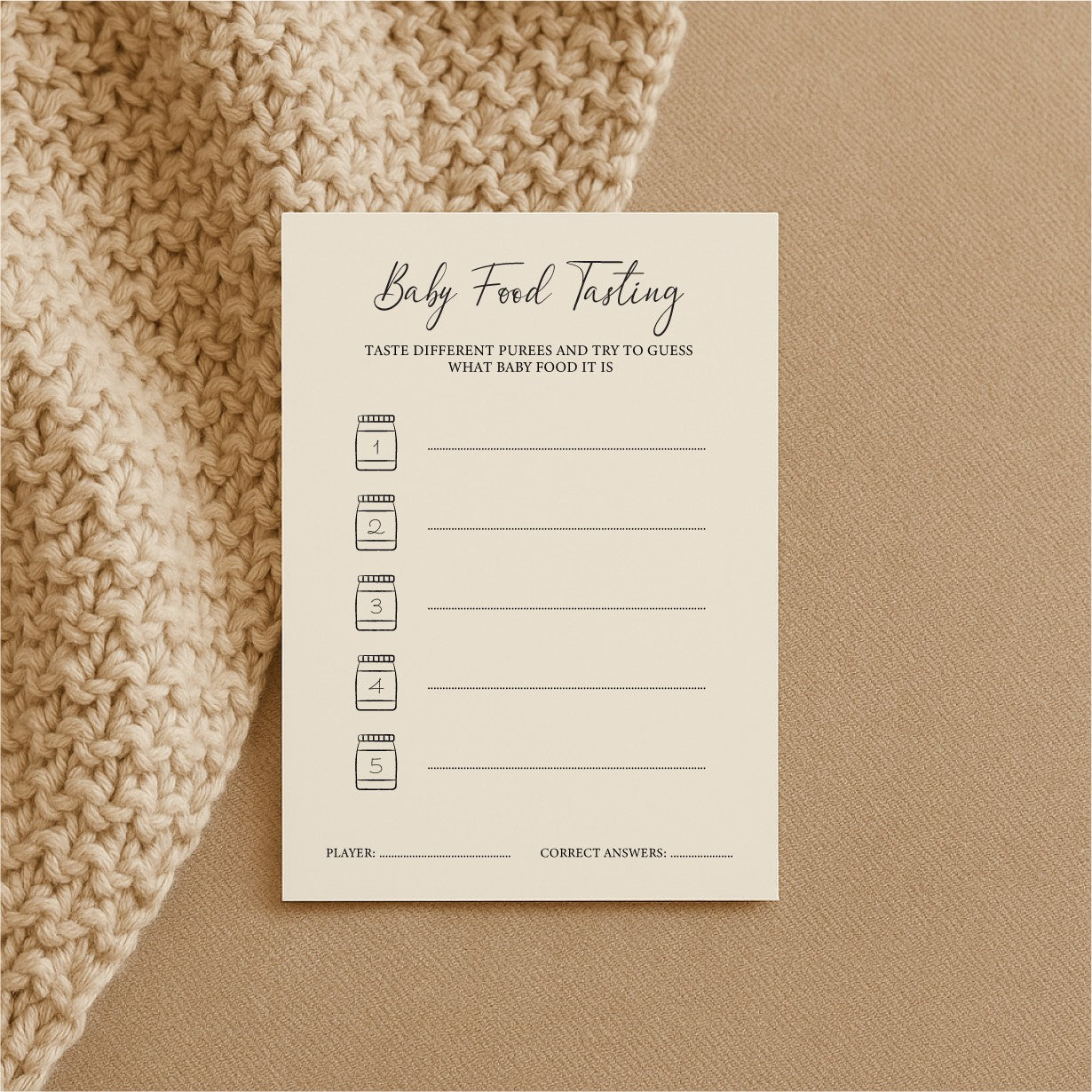 a bold close-up of baby shower food tasting game cards on a dark table, ready for mystery puree guessing