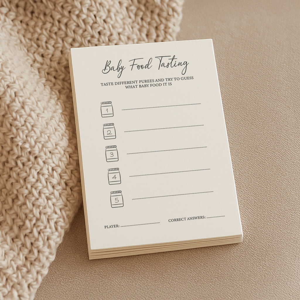 a soft-lit close-up of baby shower food tasting cards on a cozy linen tablecloth
