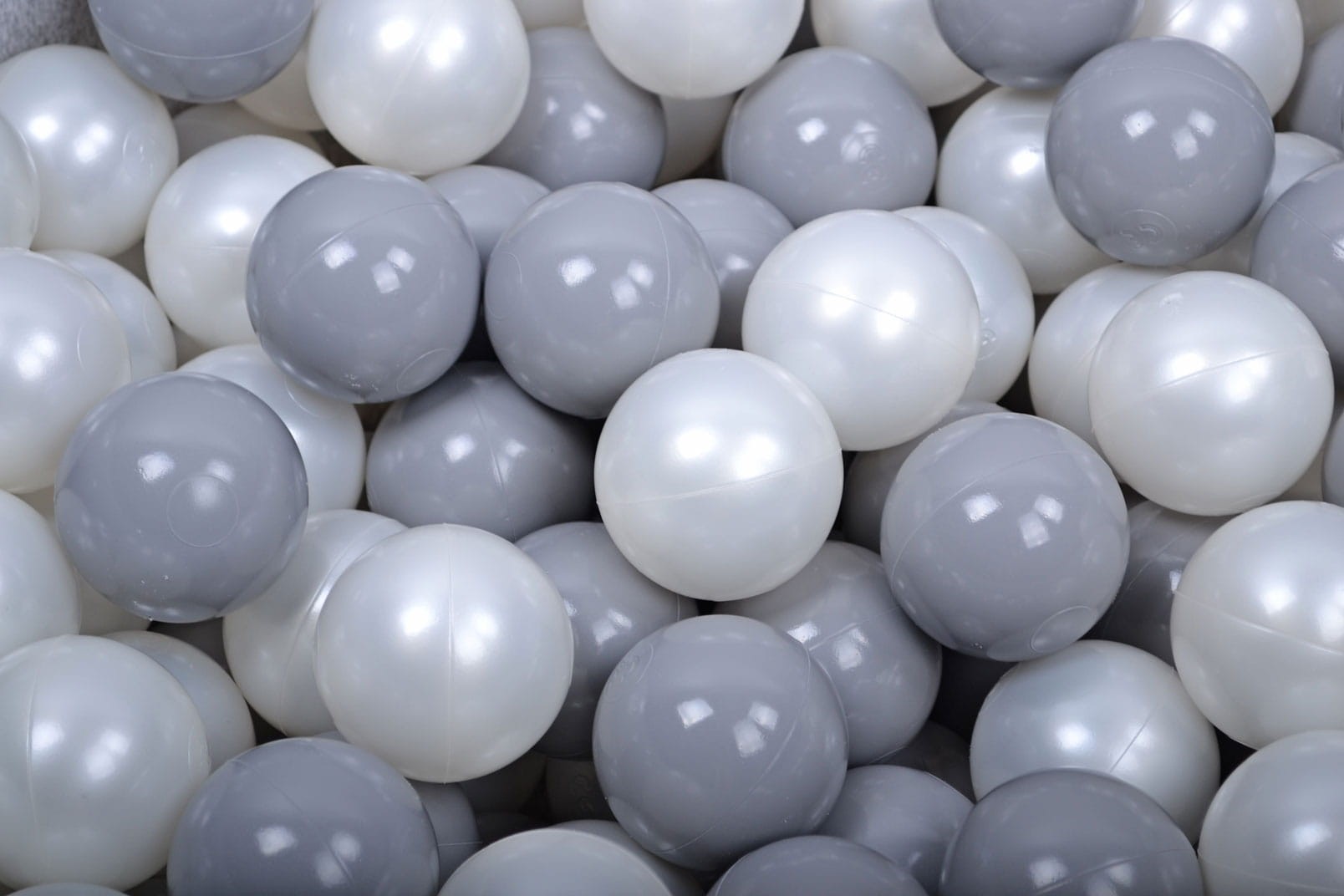 bold close-up of 200 gray and white pearl ball pit balls for sensory play