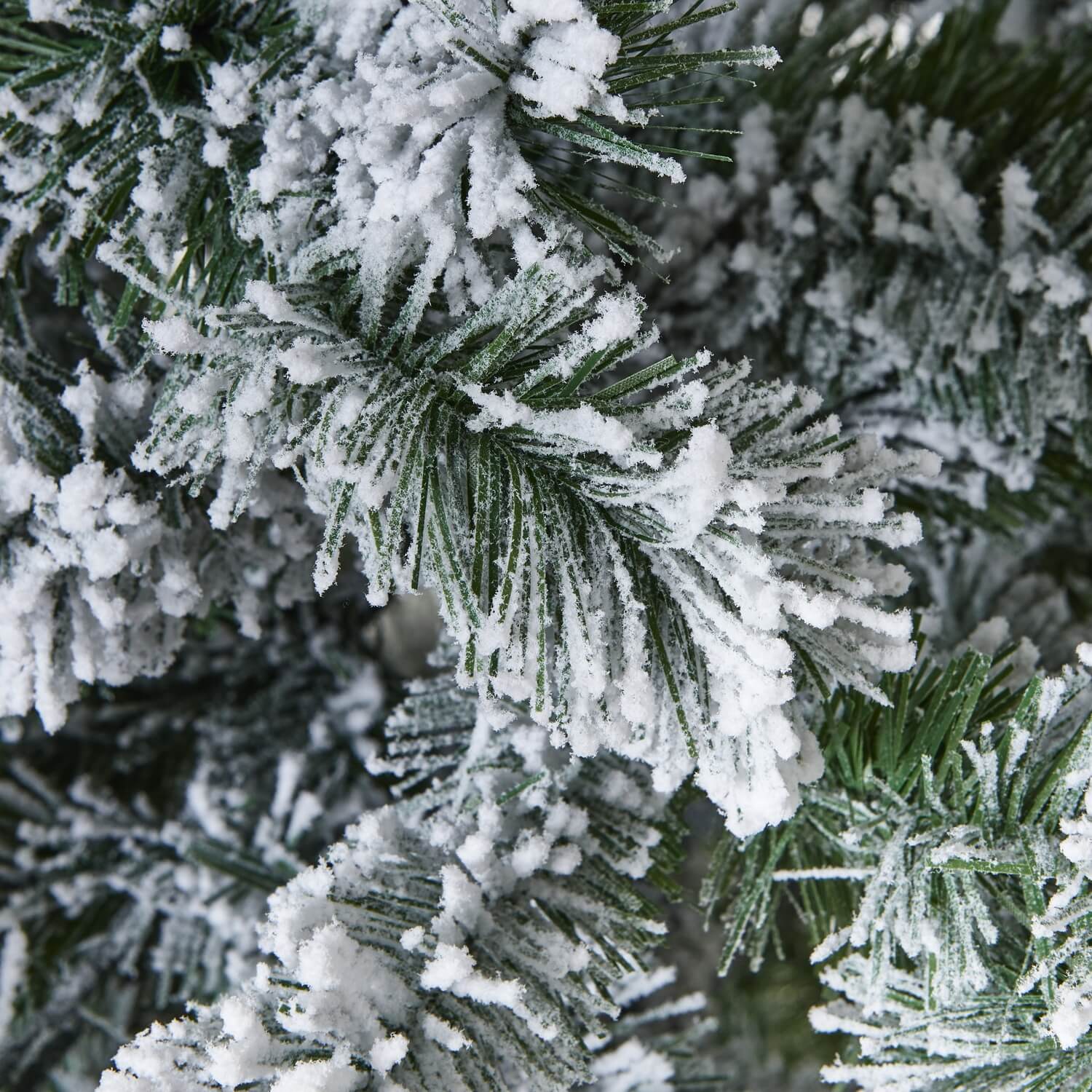 Extra large 210cm snowy spruce artificial Christmas tree with lifelike snow-dusted branches and realistic needle detailing by Sostter at brixbailey.com