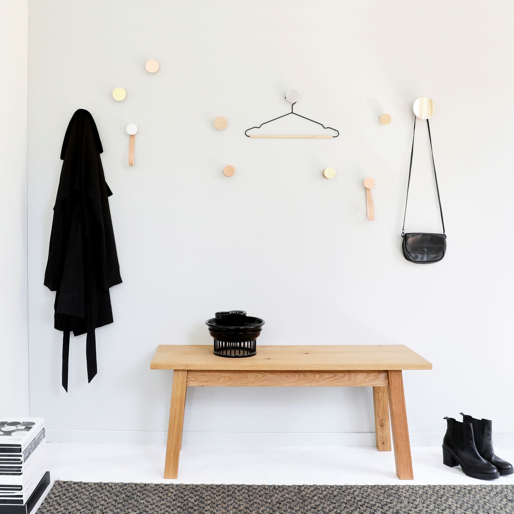 elegant beech wood and copper wall hook in soft, refined light on a minimalist background