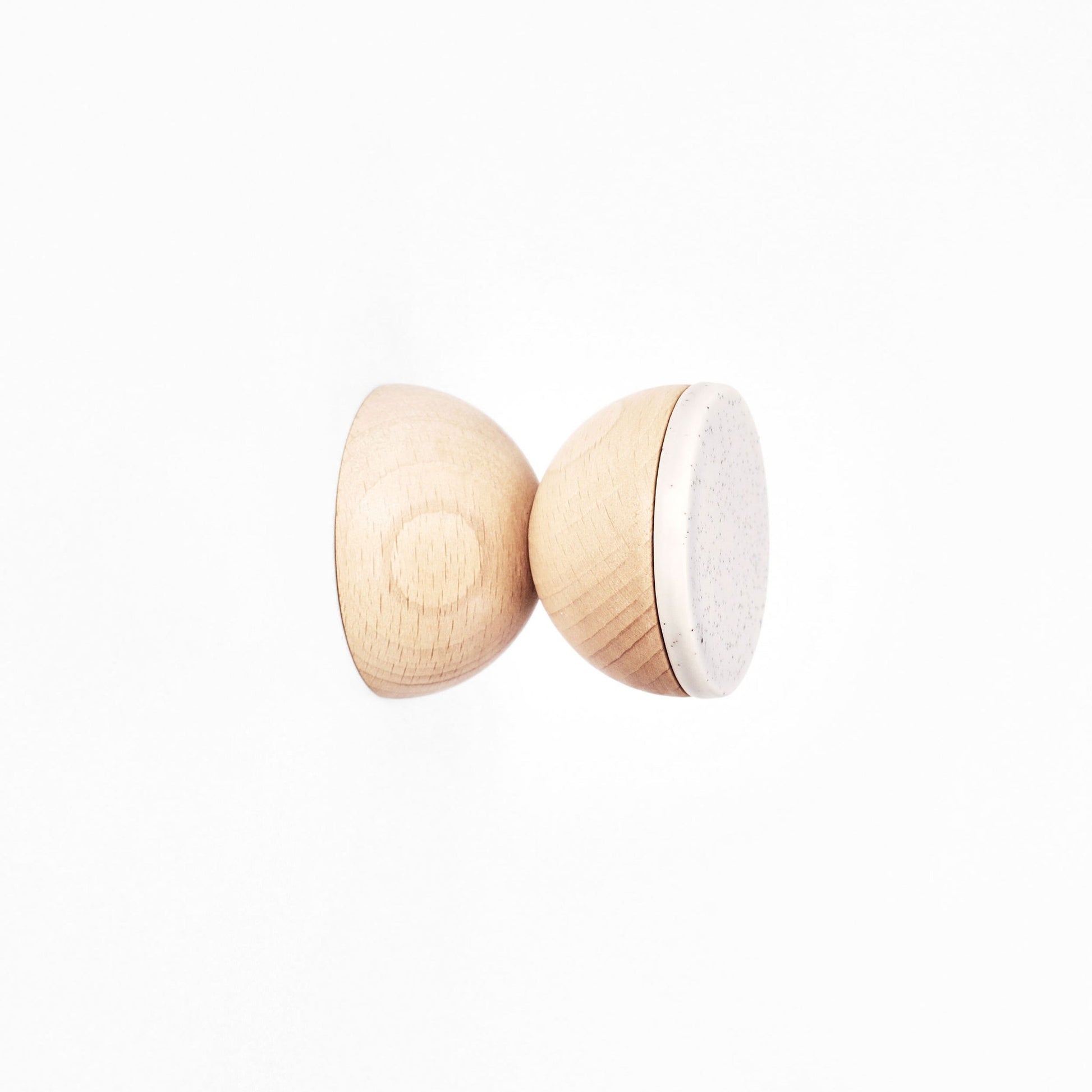 grey sand ceramic and beech wood wall hook mounted on a light oak panel in a hallway