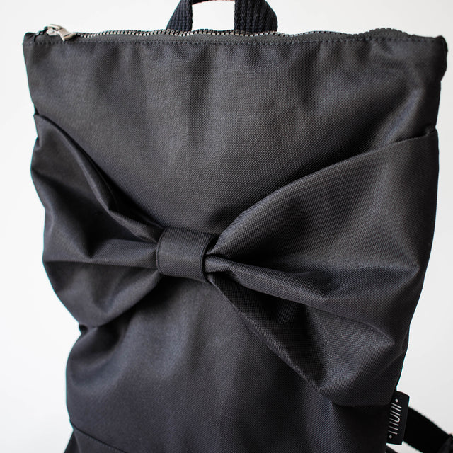 Black Bow Backpack – Elegant, Waterproof & Multi-Pocket by Muni at www.brixbailey.com