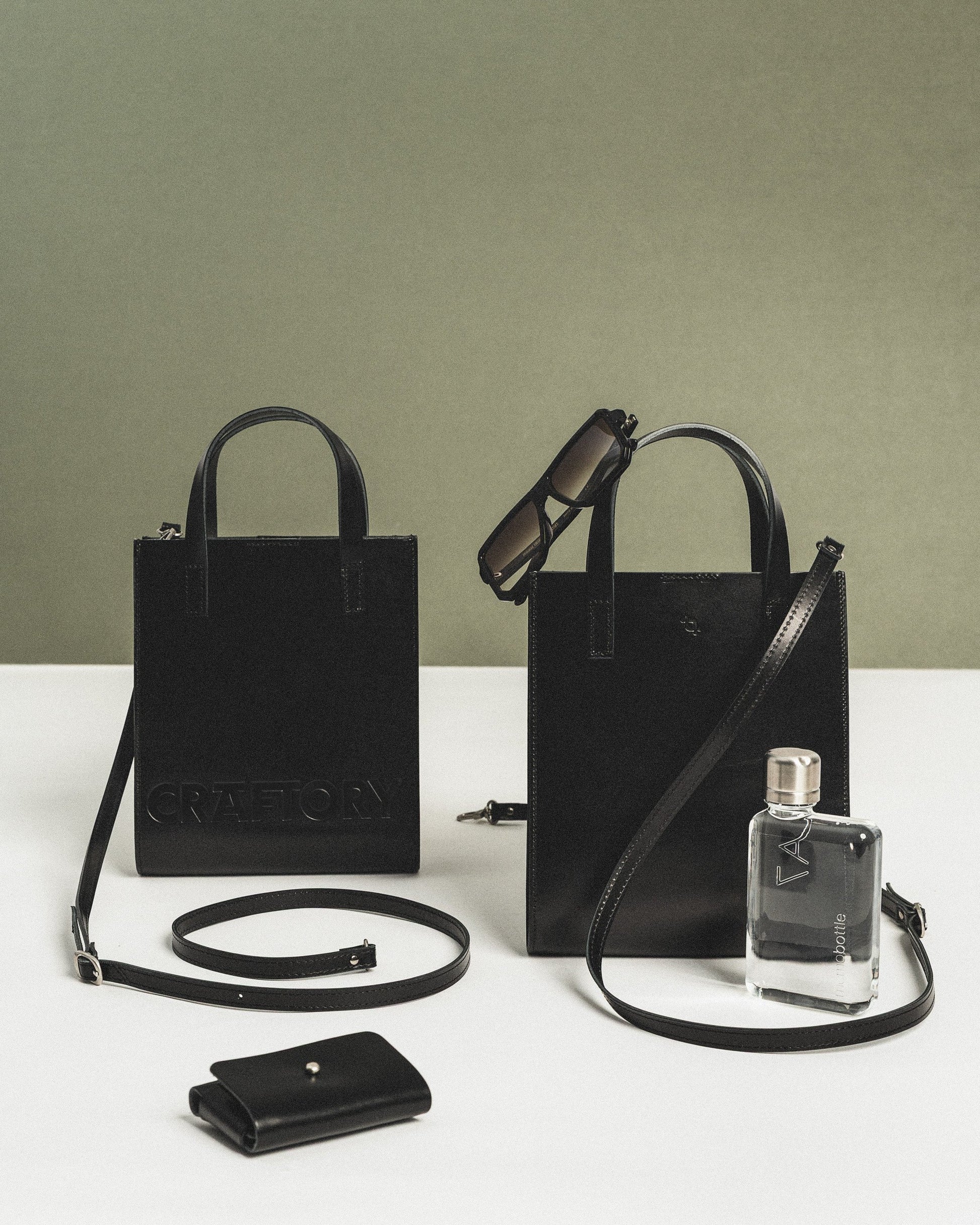 elegant black leather bucket handbag with a refined silhouette and adjustable strap