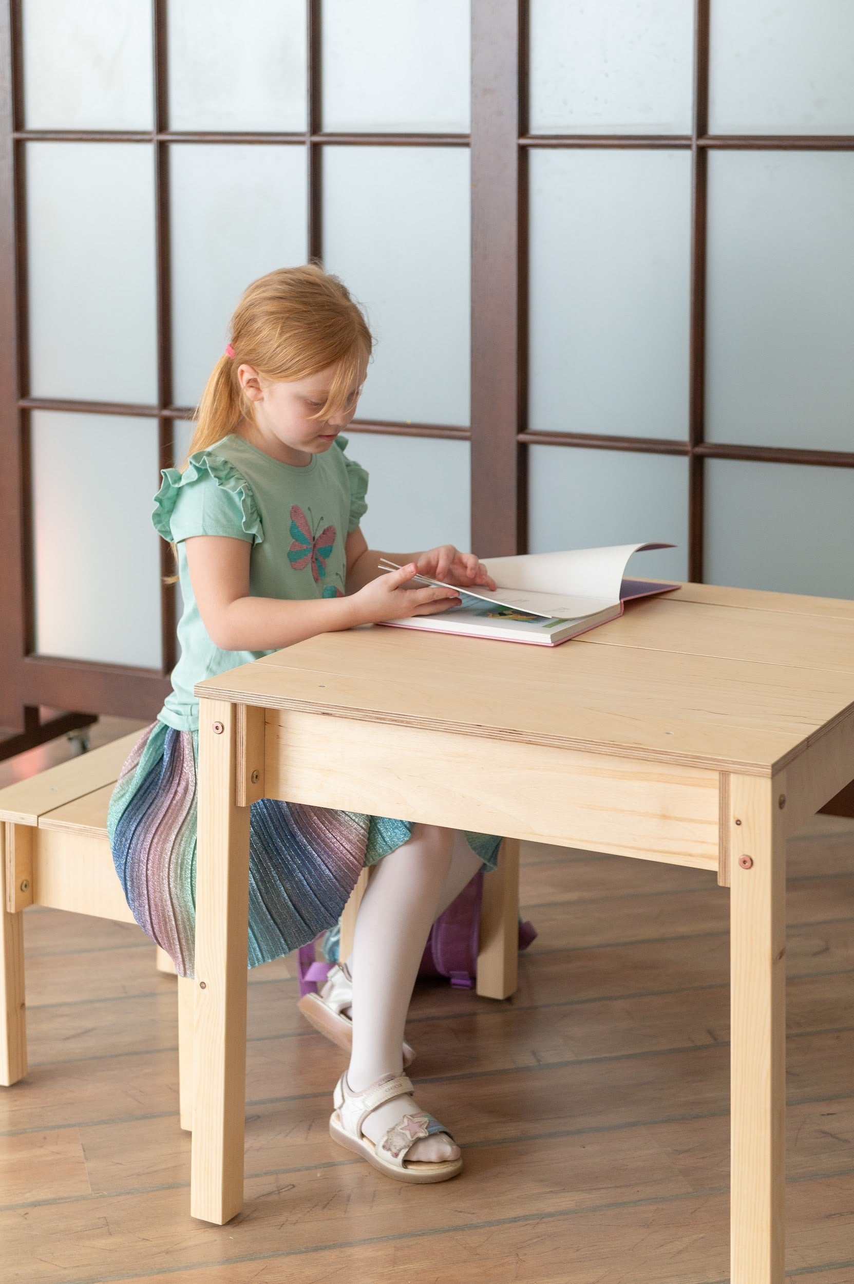 a functional birch wood kids table and chair set with storage in a bright, organized playroom