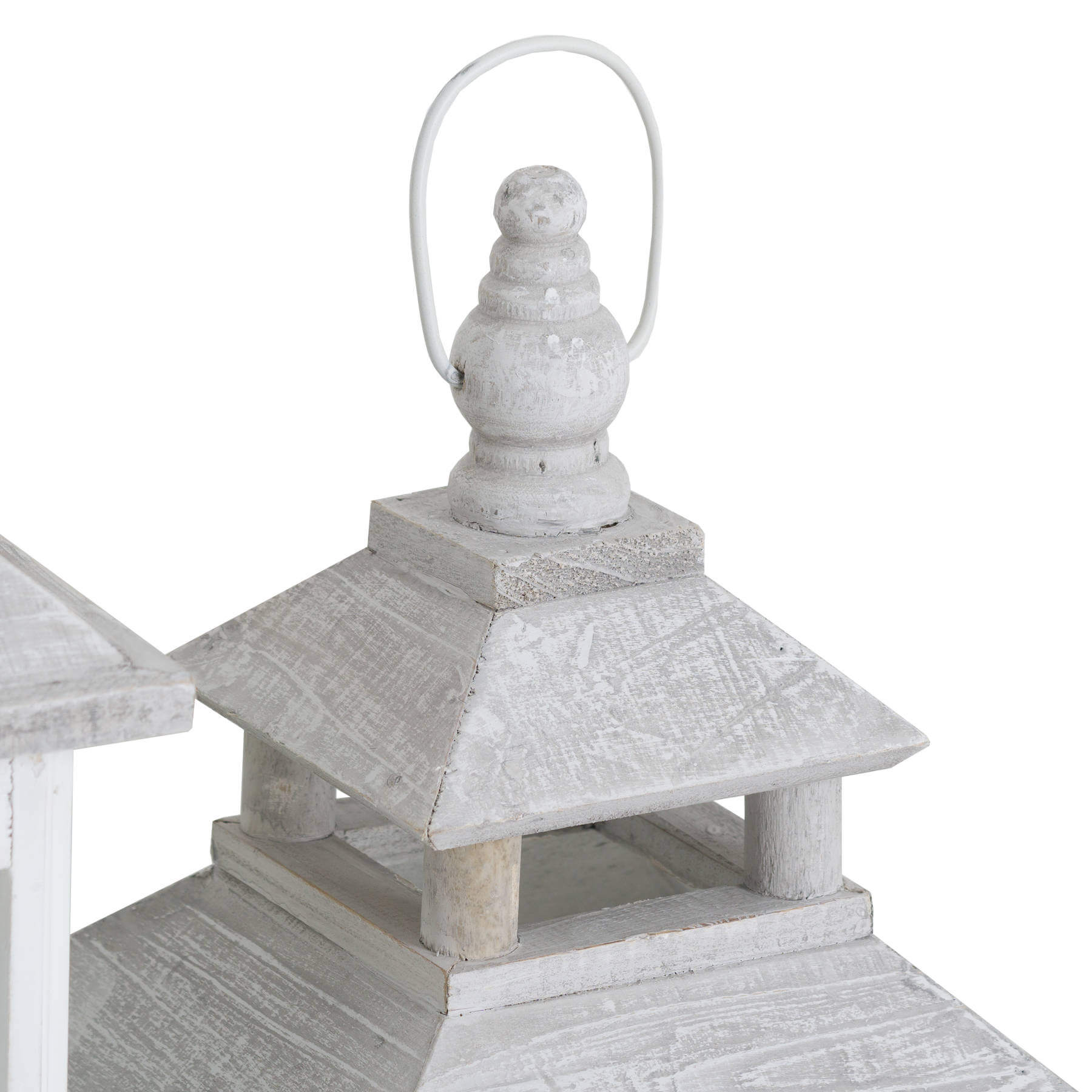 White wooden lantern with intricate window detailing, casting beautiful light patterns for coastal or Scandinavian decor. by RoomLondon at brixbailey.com