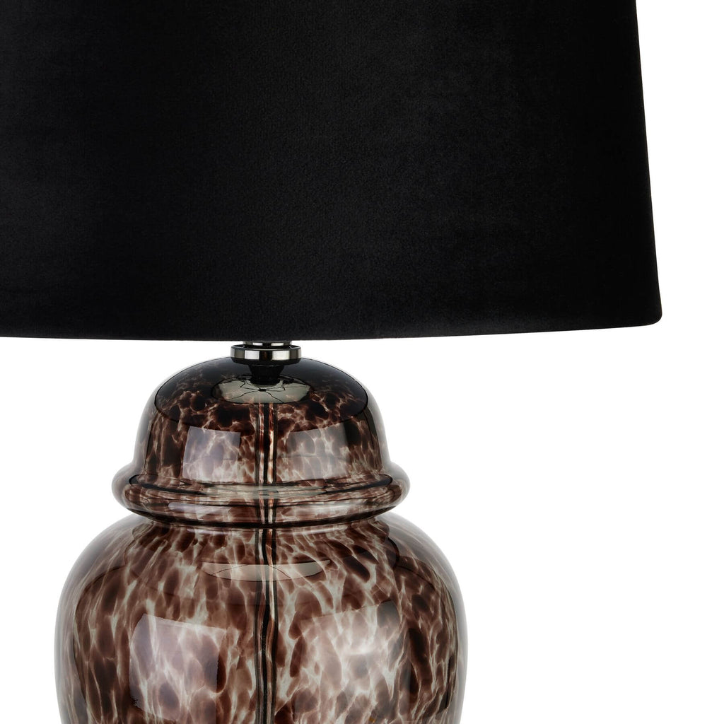 Handcrafted black and grey glass table lamp with velvet shade, casting dappled light patterns for modern decor. by Sostter at brixbailey.com