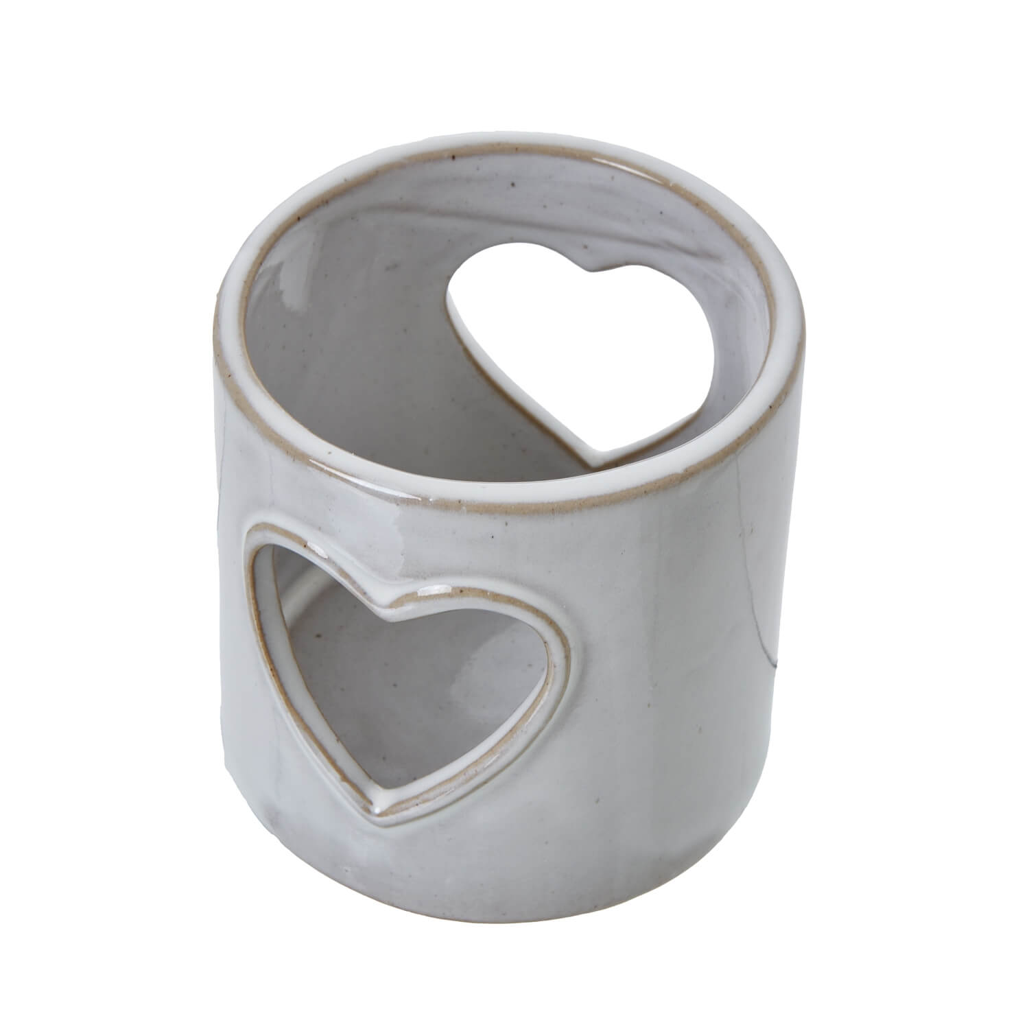 White ceramic tealight holder with heart cutouts, casting romantic shadow patterns for cozy ambiance. by RoomLondon at brixbailey.com