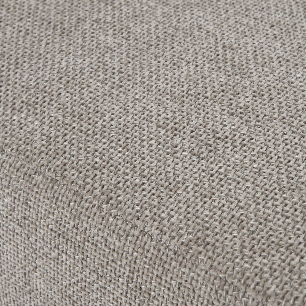 Taupe velvet ottoman footstool with wooden legs, plush cushioning, and modern farmhouse design by sostter at brixbailey.com