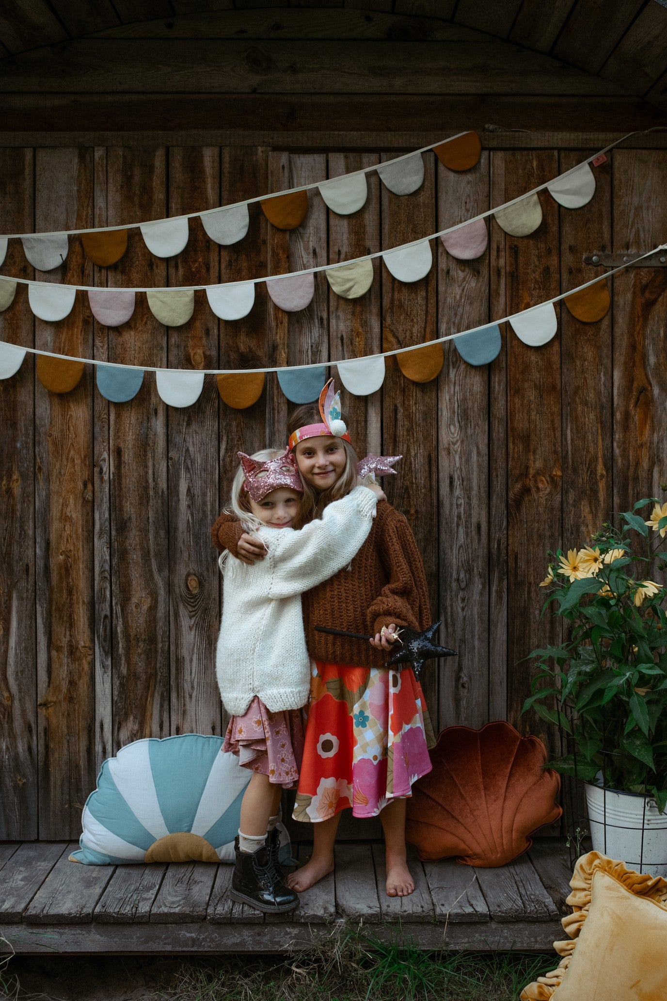 a playful child wearing a glittery gold cat mask, laughing during a sunny afternoon playdate