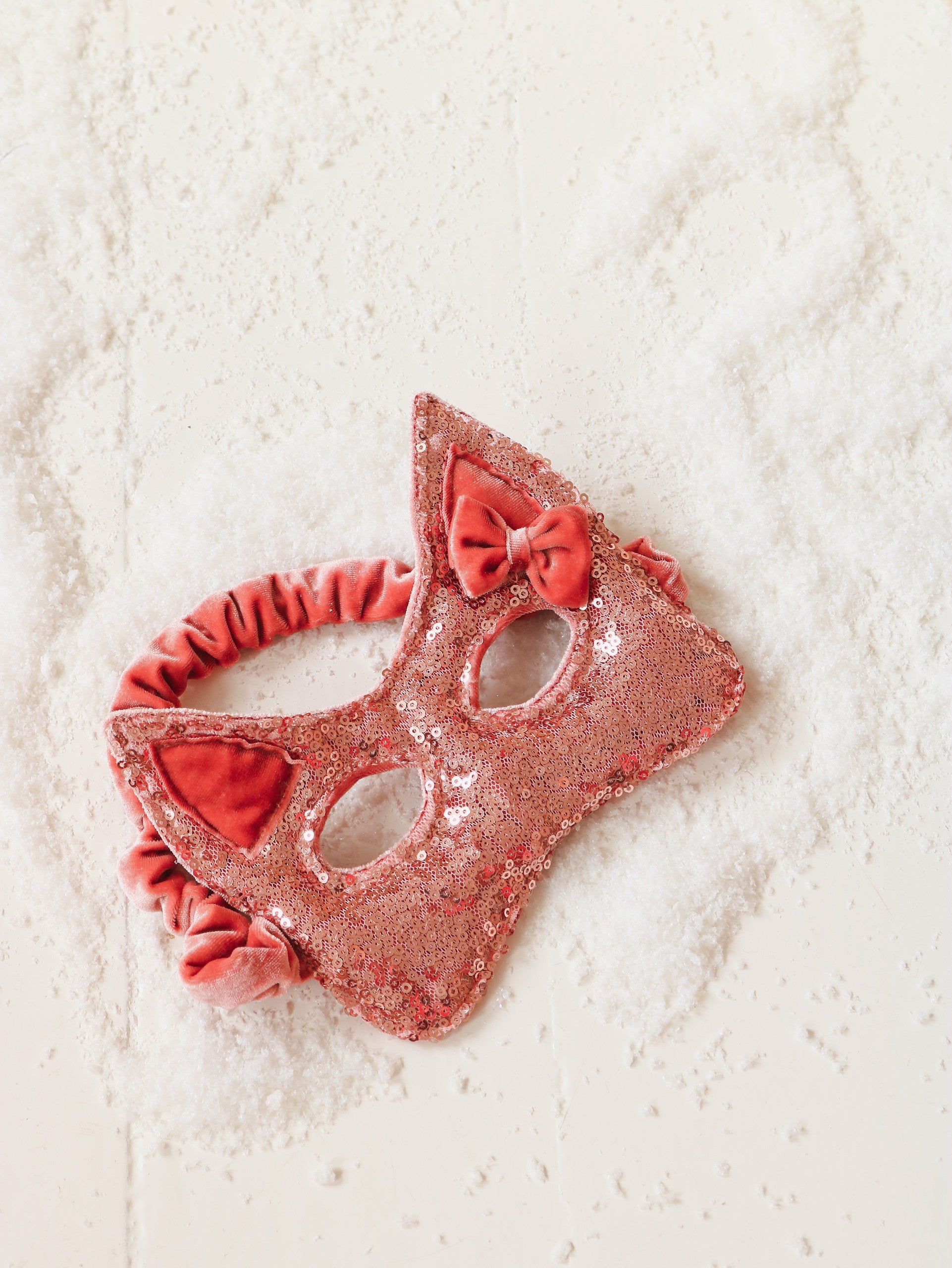 pink sequin cat mask sparkling in soft light, perfect for fairy tale adventures and playful dress-up