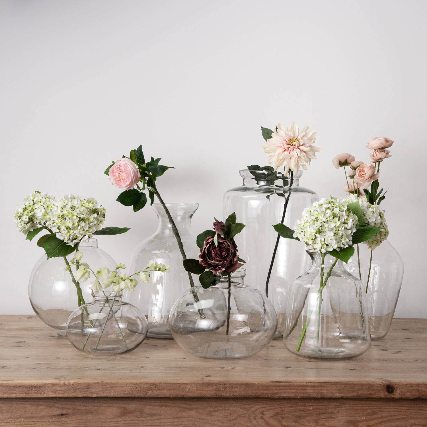 Clear glass Hydria vase with tapered neck and rounded base, perfect for floral arrangements or standalone decor. by RoomLondon at brixbailey.com