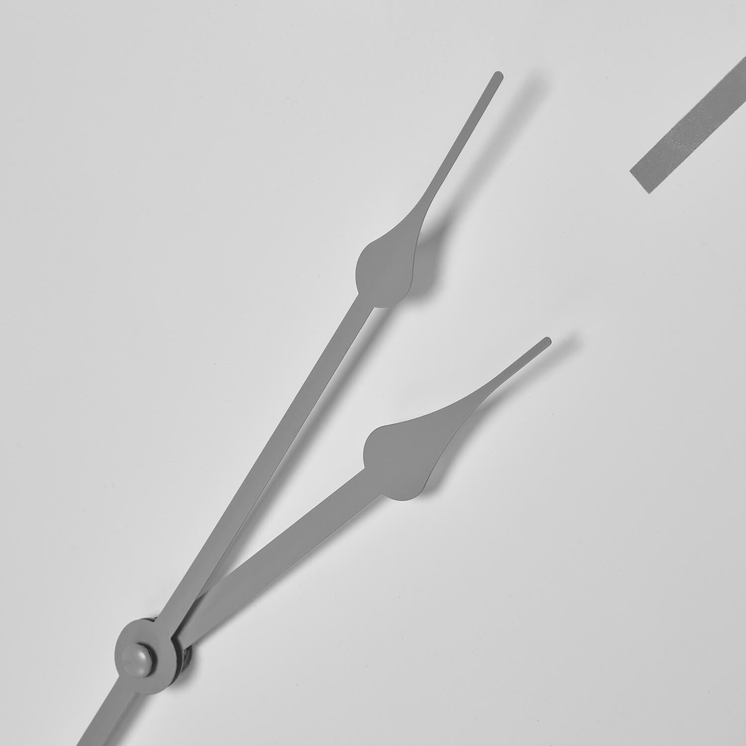 White minimalist metal wall clock with industrial-chic design, contemporary home decor statement piece by Sostter at brixbailey.com