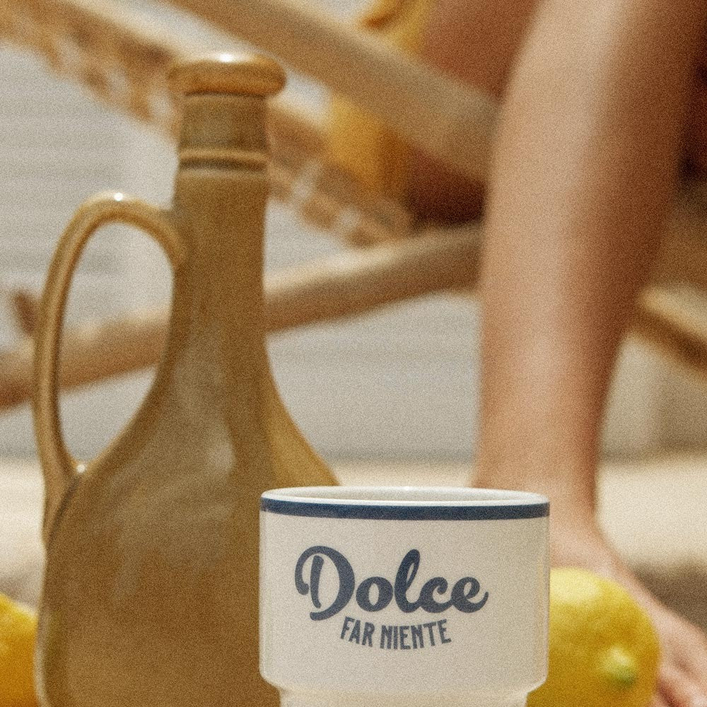 dolce far niente ceramic mug in warm morning light on a rustic wooden table
