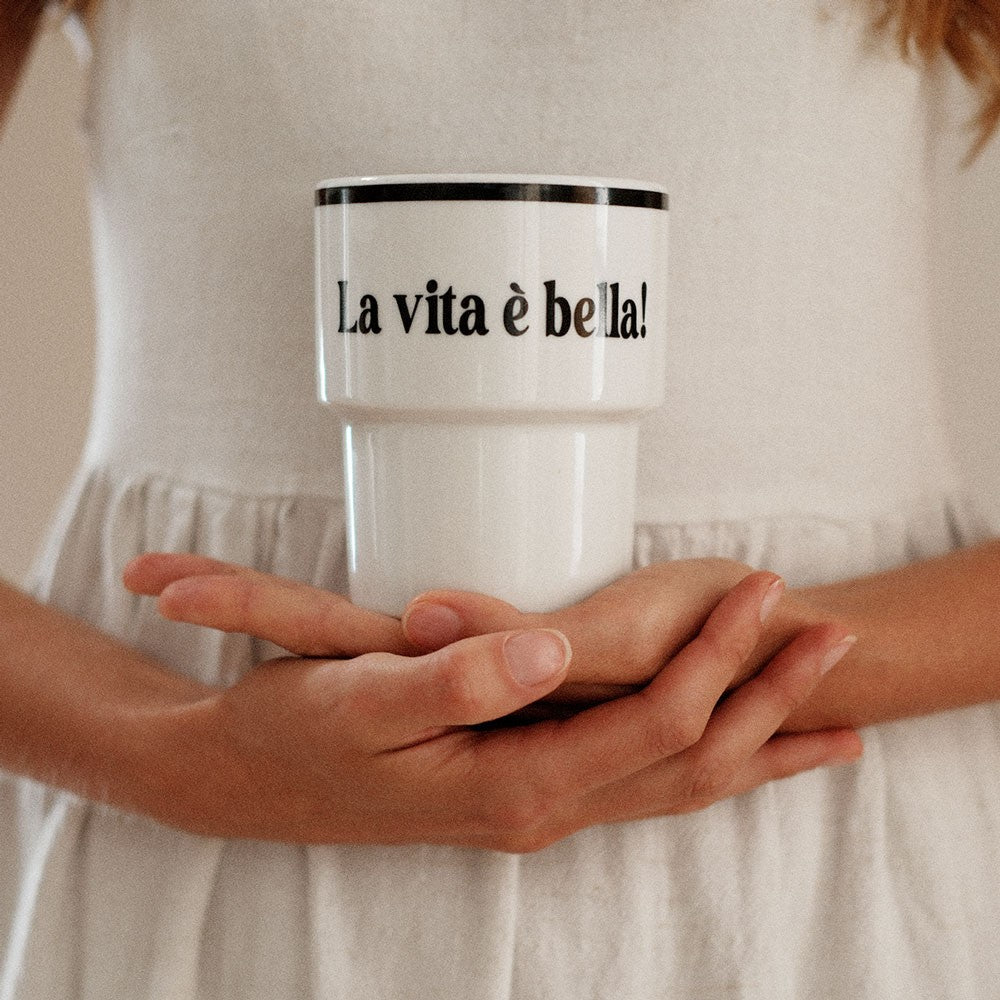 bold la vita e bella ceramic mug with italian typography on a sun-drenched rustic table