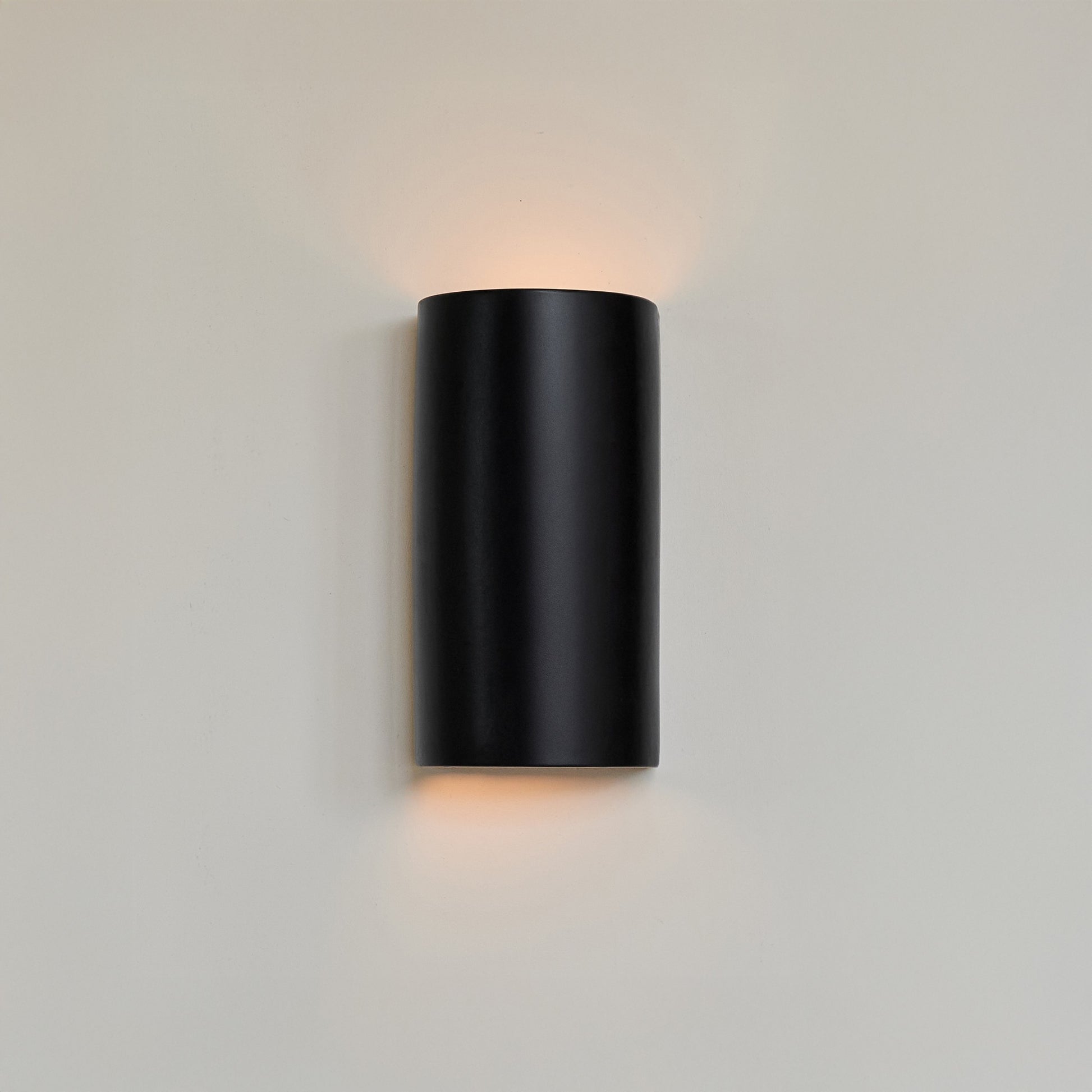 a bold, close-up view of the matte black curve ceramic wall light